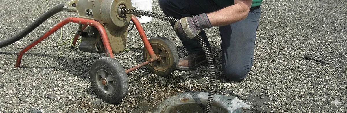 sewer rodding technician actively removing blockages from a sewer line in Richmond, VA